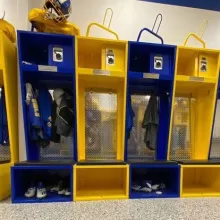Blue and yellow Flex Elite lockers with helmet racks and team gear.